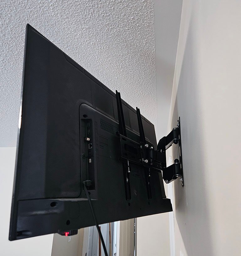 TV wall mount installation with hidden cable management in Toronto residential property