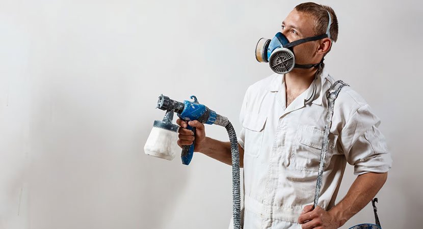 Professional house painter painting interior walls in a Toronto home