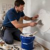Drywall repair cost in Toronto — handyman patching a wall in a Toronto condo