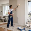Professional painter rolling a fresh coat of paint on an interior wall in a Toronto home